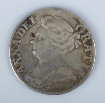 A Queen Anne silver shilling dated 1709.