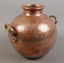 An Eastern copper vessel with engraved decoration. (23cm)