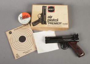 A boxed Webley & Scott 'Premier' model .22 caliber air pistol. Includes tin of .22 pellets, target