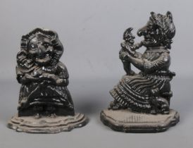 Two cast iron door stops in the form of Punch and Judy. Approx. height of tallest 30cm.