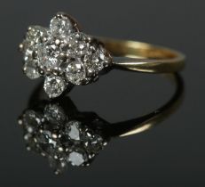 An 18ct gold nine stone diamond cluster ring, approx. .5 carats total. Size K, 2.5g.