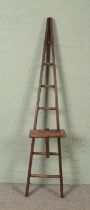 A seven rung wooden A-Frame ladder, possibly for fruit picking, with a platform step. Height: 204cm.