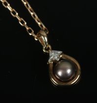 A 9ct gold pendant on chain set with single pearl and diamond. Total weight 3.4g.