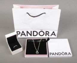 A boxed silver Pandora pendant on chain along with a boxed silver Pandora ring. With original bag.