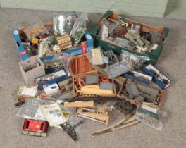 Three boxes of model railway accessories. Includes Hornby platform straights and station