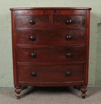 A Victorian mahogany bow front chest of drawers with two short over three long drawers, raised on