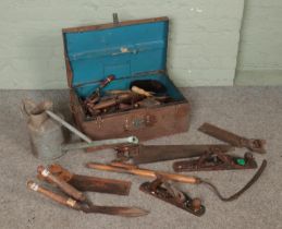 A vintage tin trunk with contents of tools along with a galvanised watering can. Includes Stanley