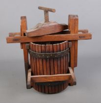 A small cast iron and wooden fruit press. Approx. dimensions 42cm x 41cm.