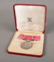 A Queen Elizabeth II British Empire Medal with ladies ribbon bow, displayed in case of issue. Issued