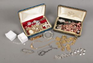 Two jewellery boxes with contents of costume jewellery. Includes bracelets, beads, silver pendant