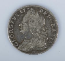 A George II silver sixpence dated 1757.