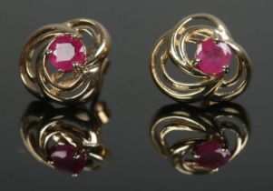 A pair of 9ct gold stud earrings set with rubies. Total weight 1.6g.