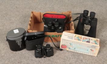 A box of assorted items. Includes Celestron and Mark Scheffel binoculars, Ronco portable sewing