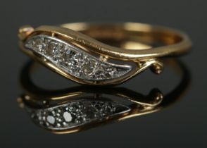An 18ct gold and scroll set five stone diamond ring. Size NÂ½, 2.3g.