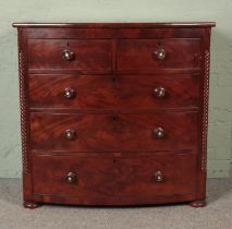 A Victorian flame mahogany bow front chest of drawers with rope twist columns. Hx110cm Wx113cm