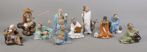 A collection of Chinese Shiwan clay figures, all stamped China to the base. One tuning pegs