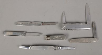 Six stainless steel pocket knives along with a set of Wilkinson Sword stainless steel nail clippers.