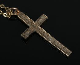 A 9ct Gold crucifix pendant, on yellow metal chain. Weight of pendant: 1.1g.