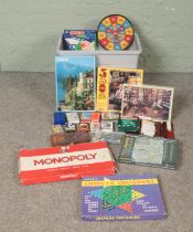A box of assorted games, toys and cards. To include jigsaws, Monopoly, Mastermind and Chinese