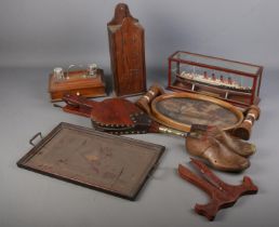 A box of woodenwares. Includes wall hanging candle box, trays, desk stand, ship in display case,