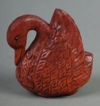 A hand carved hardwood netsuke of a swan, signed to base.