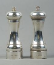 A silver 'Peter Piper' salt and pepper mill set, both assayed for London, 1996 and 1997, by John