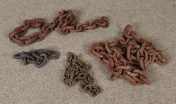 A collection of large thick cast iron chains.