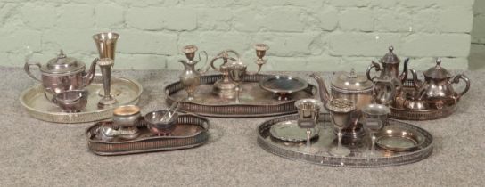 A large box of assorted silver plate and metalwares, to include four piece tea set, serving trays,