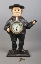 A cast iron John Bull 'blinking eye' banjo clock, with key. 38cm tall.