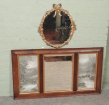 A oak framed over mantel mirror flanked by two panels along with a ornate gilt framed mirror. Mantel