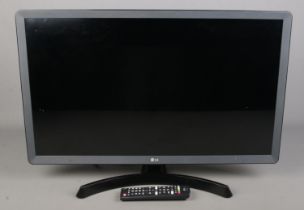 An LG 28" smart television with remote. In working order.
