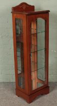 A slender display cabinet with mirrored interior. (133cm x 42cm x 31cm)