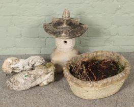 A concrete planter along with three concrete garden ornaments. Includes two lion example, etc.