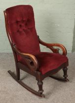 A Victorian mahogany red upholstered rocking chair