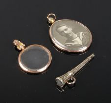 Two 9ct gold photograph lockets, along with an engine turned watch key with inset stone.