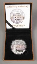 A coloured silver 2oz coin depicting palaces of St. Petersburg in case with certificate.
