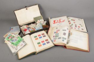 A large collection of stamps from around the world in several albums including some mint examples