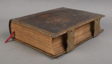 A leather bound Brown's Self Interpreting Family Bible. With gilt decoration to cover, brass