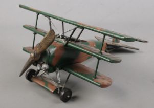 A painted metal model of a tri-plane fighter. (34cm)