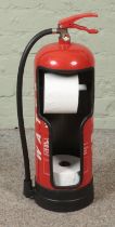 A fire extinguisher converted into novelty toilet roll holder.