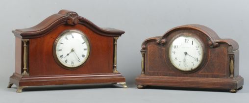 Two wooden cased mantle clocks, both with brass column supports. To include an oak cased example