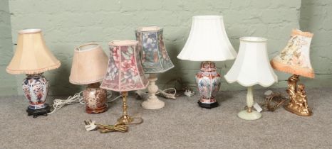 A collection of assorted table lamps to include oriental, gilt figural and hardstone examples.