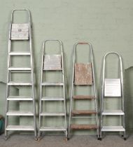 Four sets of aluminum and metal step ladders, including Abru and Clima examples.