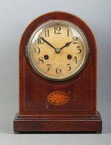 A mahogany cased dome top mantle clock, with fan patera inlay. Raised on stepped base and brass