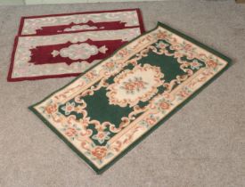 Three modern rugs to include a pair manufactured by Peking Rugs, all featuring floral design. Red