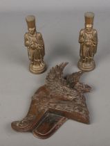 A collection of military themed brass to include winged Roman helmet wall plaque and two heavy