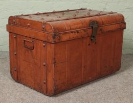 A vintage twin handled tin steamer trunk.