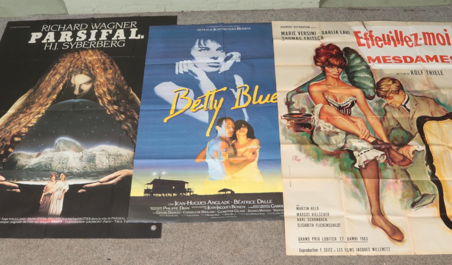 A collection of three large cinema foyer posters including Parsifal (1982), Betty Blue (1986) and
