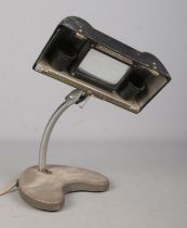 A 1940's E.D.L Lens Lite Hawk magnifying desk lamp with bakelite cover and weighted base.