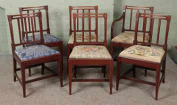 A set of six mahogany Sheraton style inlaid dining chairs including single carver featuring mis
